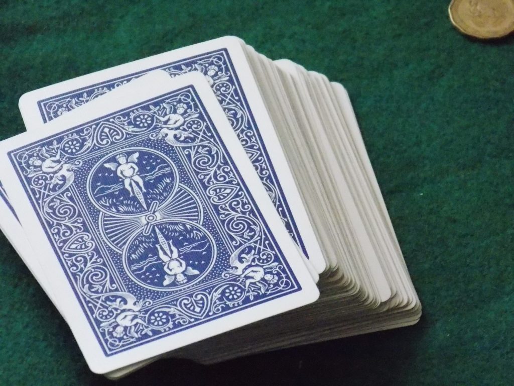 deck of playing cards on a green table