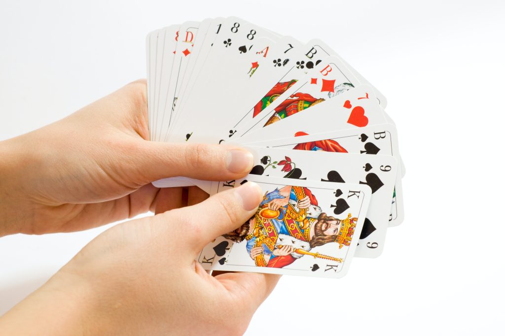deck of cards fanned out in a person's hand
